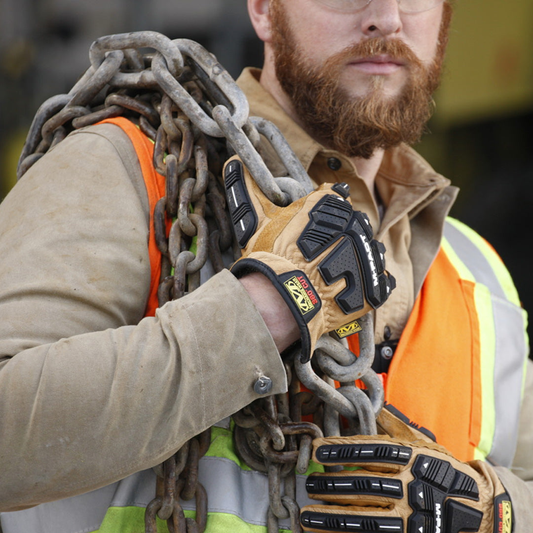 construction worker carrying heavy steel chains while wearing mechanix wear m-pact driver f9-360 cut resistant gloves in brown leather with black impact guards